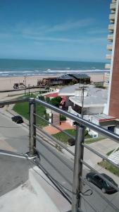 a view of the beach from the balcony of a building at Punta Gesell in Villa Gesell