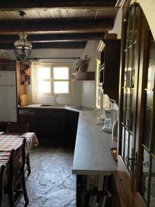 a kitchen with a counter and a sink and a window at Aiolos in Skala