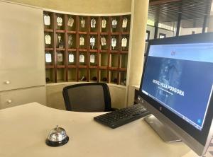 a desk with a computer monitor and a keyboard at Hotel Podgora Nuova Gestione in Rimini