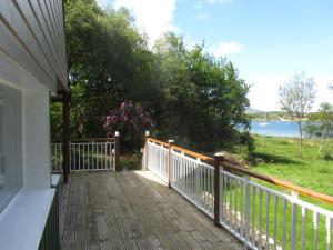 a porch of a house with a view of the water at Beachcombers in Craobh Haven