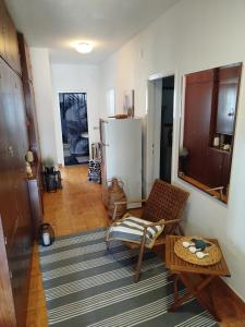 a living room with a table and a refrigerator at ROOMS LUCE 2 & Supetar in Supetar +21 photos
