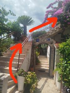 a set of stairs with orange arrows pointing up at ROOMS LUCE 2 & Supetar in Supetar