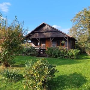a house with a green yard in front of it at Domek Zapach Wyspy in Gdańsk