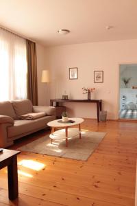 a living room with a couch and a coffee table at Hotel Habichtstein in Alexisbad