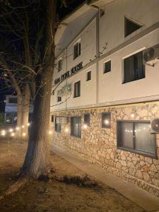 a building with a tree in front of it at Vama Stone House in Vama Veche +52 photos