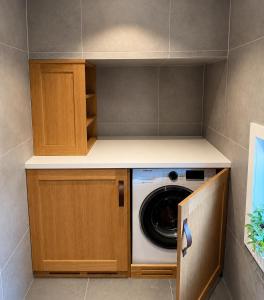 a laundry room with a washer and dryer at Sunny Garden Stay in Sandvika