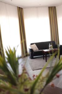 a living room with a couch and a table at Hotel Habichtstein in Alexisbad