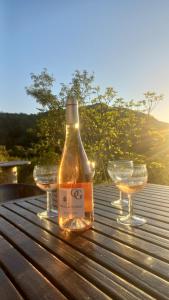 a bottle of wine sitting on a table with two glasses at A casa di Francesca in Marignana +24 photos