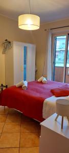 a large red bed in a room with a window at Casa Vacanze Indaco in Mascali
