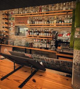 a bar with a shelf with bottles of alcohol at Belvedere Hotel & Suites in Himare