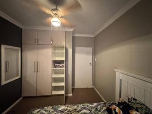 a bedroom with a bed and a ceiling fan at Healboys Self - catering Accommodation in Bonnievale