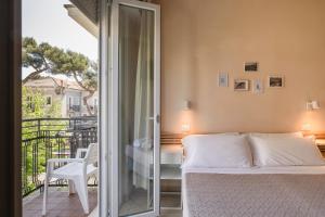 a bedroom with a bed and a balcony at Hotel Arlecchino Riccione in Riccione +116 photos