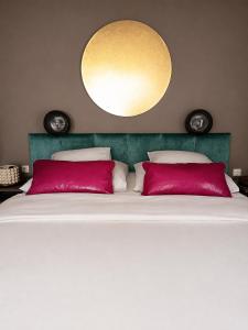 a bedroom with a large bed with red pillows at Villa Fritzi in Pörtschach am Wörthersee