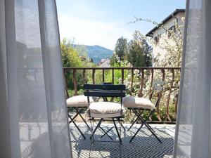 a table and two chairs on a balcony at Villa Fritzi in Pörtschach am Wörthersee