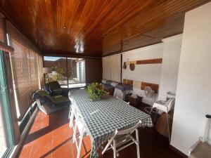a living room with a table and a couch at Casa do Meco - Private Pool in Sesimbra