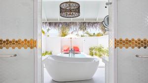 a bathroom with a large tub in a room at Sun Siyam Iru Veli - 24 Hours Premium All Inclusive Dine Around with Free Sea Plane Transfers & Exclusive Inclusions in Dhaalu Atoll +141 photos
