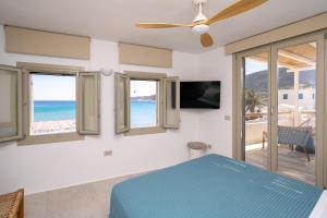 a bedroom with a bed and a view of the ocean at Turquoise in Platis Gialos