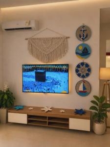 a living room with a flat screen tv on a wall at MV Ras El Hakma 190 A in Ras Elhekma
