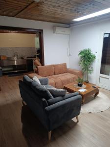a living room with a couch and a table at Cocon de Grand Anse in Petite Île