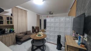 a living room with a table and a couch at City View Studio Pool - Gym - Caesar Residence in Mactan Island