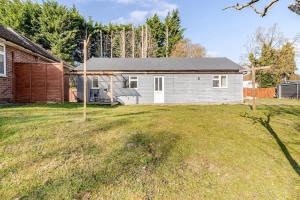 a house with a solar roof on a yard at Spacious Riverside View Bungalow in Oxford