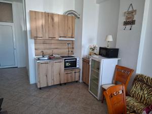 a small kitchen with a sink and a microwave at Sani Family Hotel in Byala
