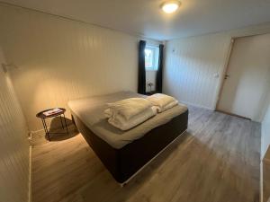 a bedroom with a bed with two pillows on it at Hammervatnet Ro in Levanger