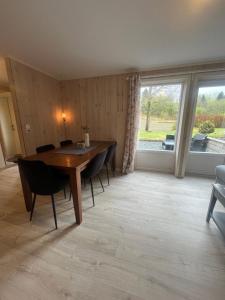 a dining room with a table and chairs and a window at Hammervatnet Ro in Levanger