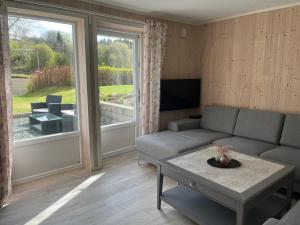 a living room with a couch and a table at Hammervatnet Ro in Levanger