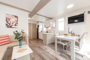 a living room with a couch and a table at Ocean Beauty Beachfront Boat House in Portorož with Sea View and Jacuzzi in Portorož