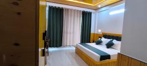 a bedroom with a bed and a window at Touch wood guest house in Dharmsāla