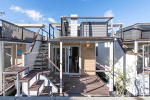 a house with stairs leading to the front door at Ocean Beauty Beachfront Boat House in Portorož with Sea View and Jacuzzi in Portorož
