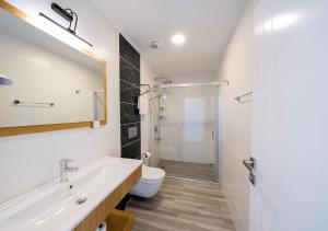 a bathroom with a tub and a toilet and a sink at Kalkan Beach Park Hotel in Kaş +79 photos
