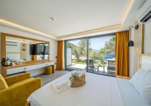 a living room with a couch and a table at Kalkan Beach Park Hotel in Kaş