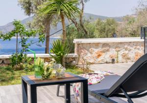 a table and a chair on a patio at Kalkan Beach Park Hotel in Kaş