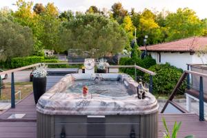 a hot tub on a deck in a yard at Ocean Beauty Beachfront Boat House in Portorož with Sea View and Jacuzzi in Portorož