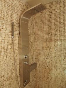 a shower with a glass door in a bathroom at Chalet Greystone in Brides-les-Bains