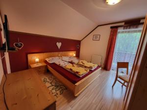 a bedroom with a bed and a table in it at Ferienhaus Gstoderblick in Seebach