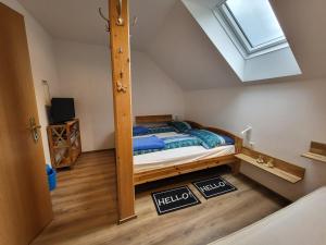 a bedroom with a bed and a skylight at Ferienhaus Gstoderblick in Seebach