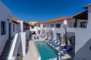 a view of a swimming pool between two buildings at Iliana Hotel in Panormos Rethymno