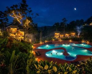 an image of a swimming pool at night at Buxton Gan Resort Hotel in San Andres