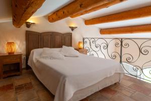 a bedroom with a white bed in a room with wooden ceilings at Chambres d'hôtes et studios de charme - A Mandria in Murato +52 photos