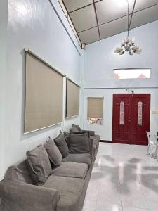 a living room with a couch and a large screen at Zari zara Apartment in San Simon