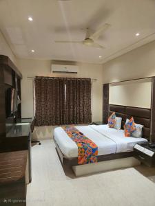 a bedroom with a large bed and a window at Hotel Santoor - Geeta Bhawan Square in Indore