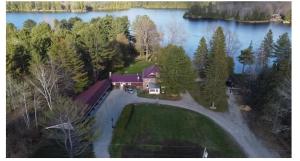 an aerial view of a house on a lake at Noble Motel On Moore Lake in Norland +38 photos
