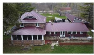 an aerial view of a house with a red roof at Noble Motel On Moore Lake in Norland