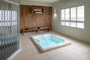 a jacuzzi tub in a room with a window at Bourbon Convention Hotel Santos in Santos +35 photos
