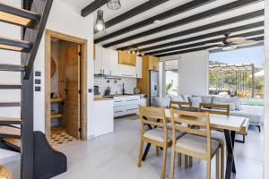 a kitchen and dining room with a table and chairs at Villa Aegea in Skopelos Town