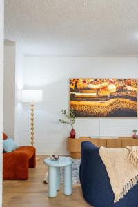 a living room with a couch and a table at Park side on East Terrace in Adelaide