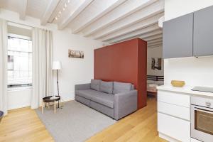 a living room with a chair and a table at CityLife in Bergamo +12 photos